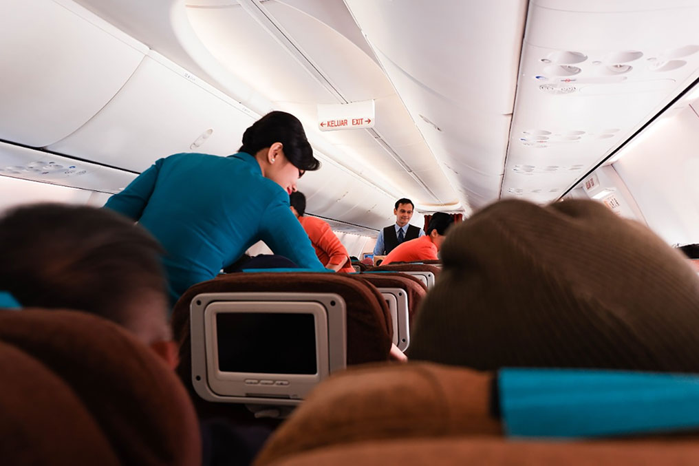 flight attendant serving passenger