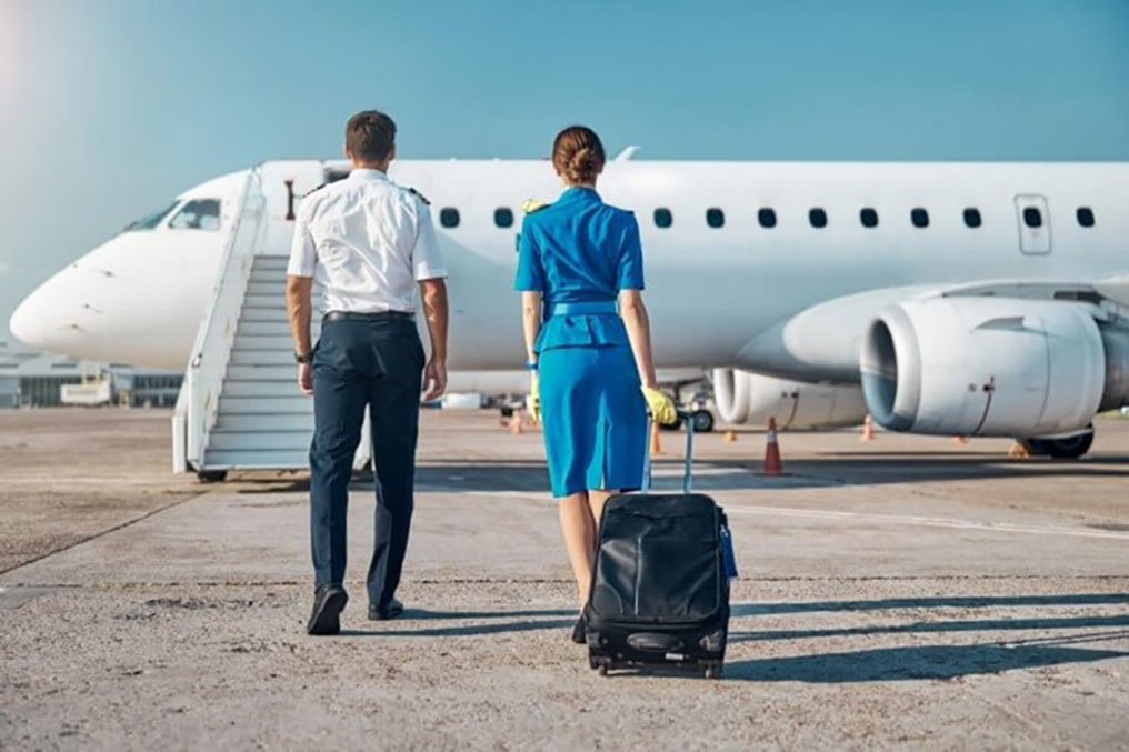 Pilot and cabin crew looking at a plane