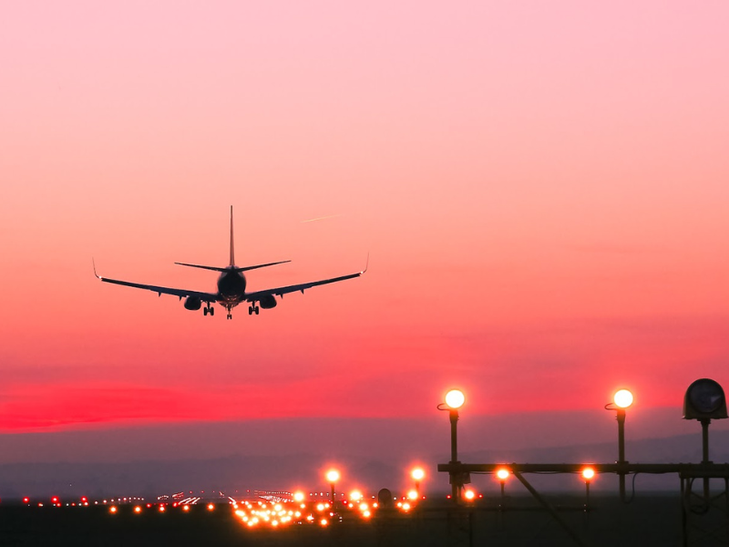 Plane landing at sunset