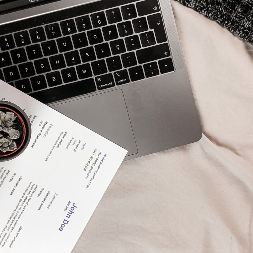 An example CV next to a laptop.