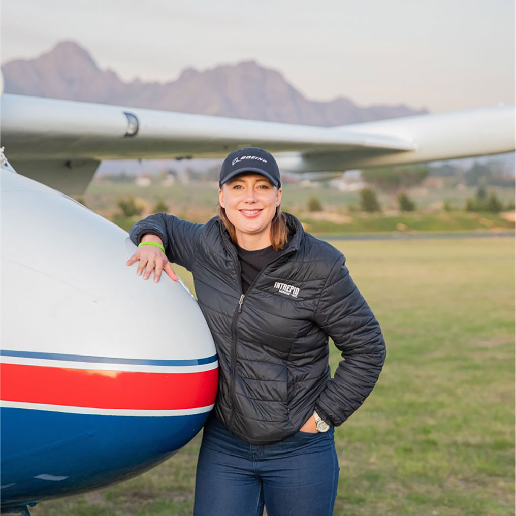 female stood next nose of a plane