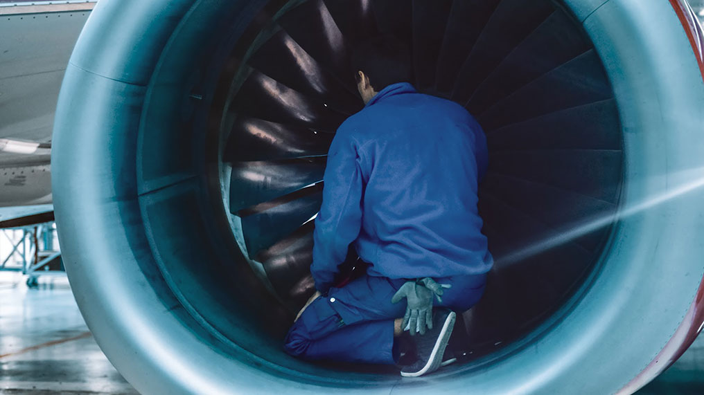 Engineer working on aeroplane turbine