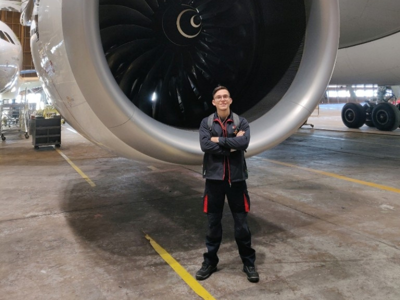 Bruno Silva, Aircraft Maintenance Engineer, stands in front of an aircraft