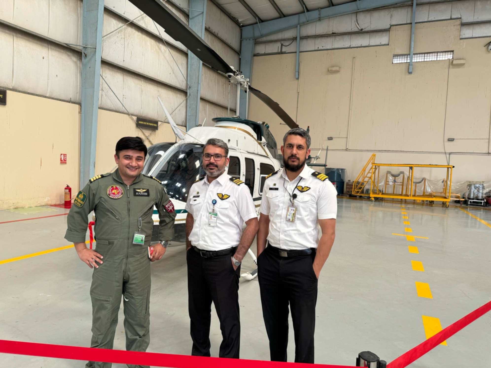 Muhammad Inayat standing with his pilot colleagues