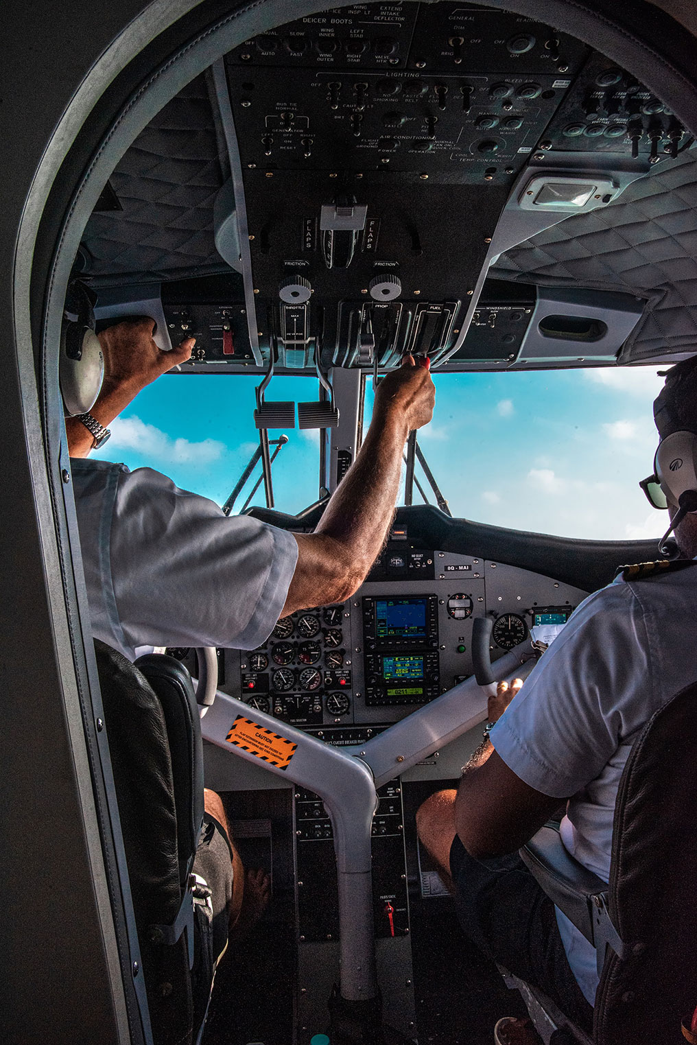 Two pilots in the cockpit flying a plane
