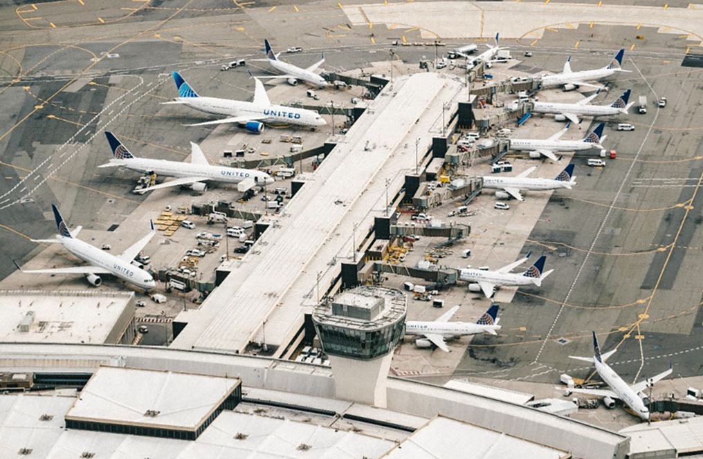 numerous planes parked at an airport