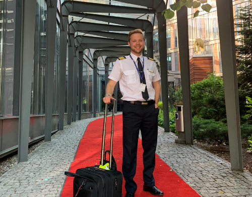 Pilot with suitcase working