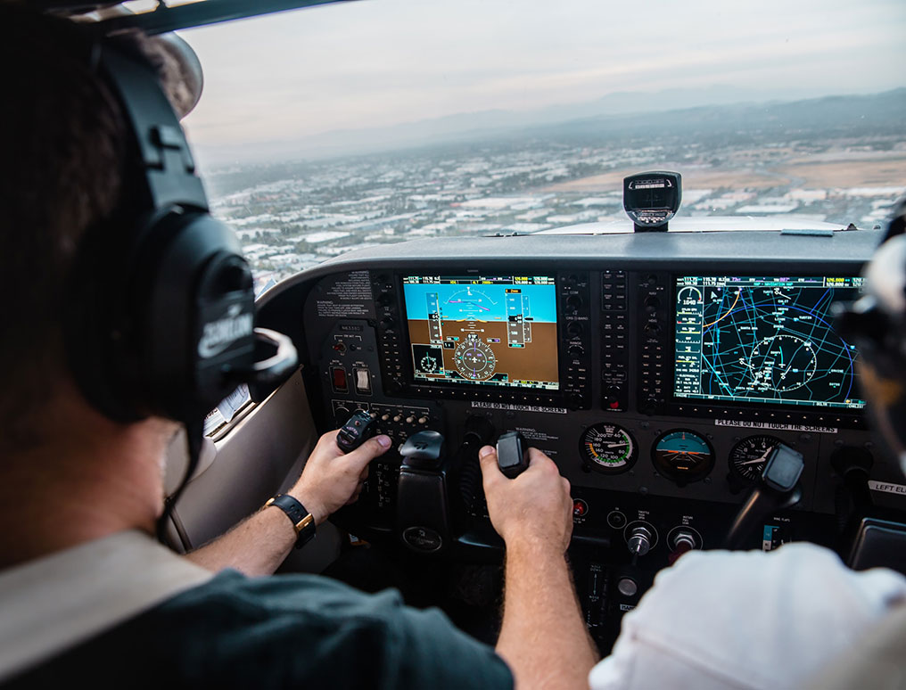 Person in cockpit flying plane