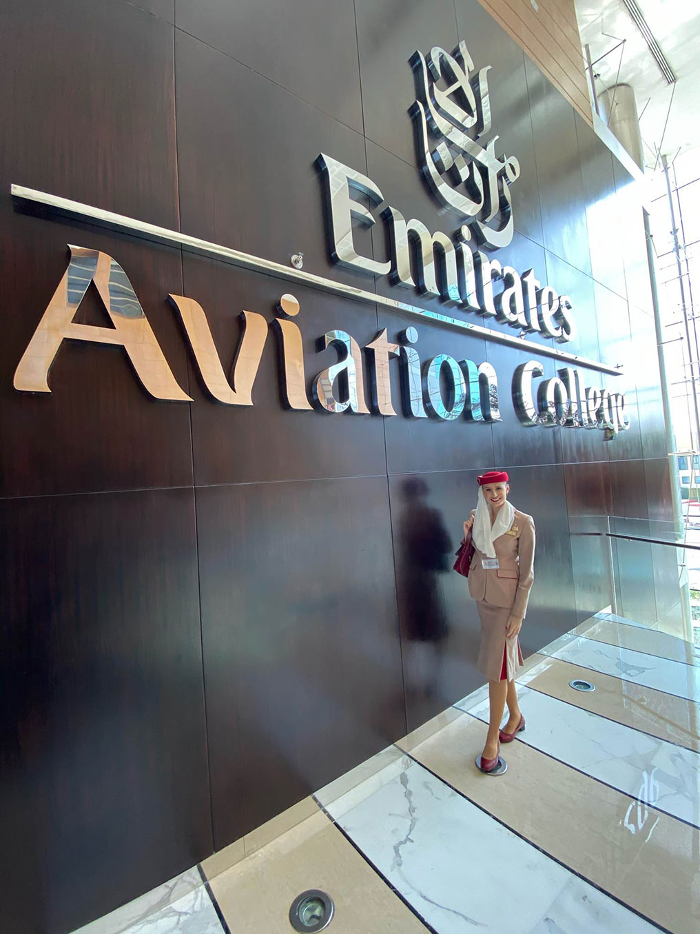 Lisiane by the Emirates Aviation College sign