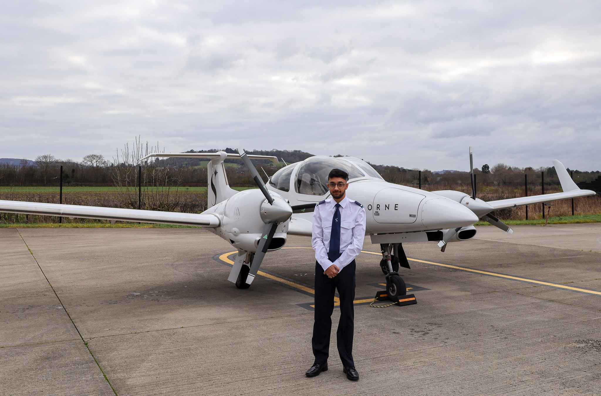 Anu Boswell standing in front of plane